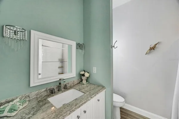 a bathroom with a granite countertop shower