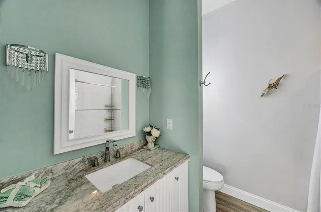 a bathroom with a granite countertop shower
