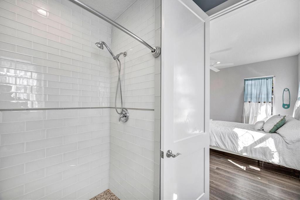 10050 Creekside Drive Placida, FL 33946 - Photo 31 of 52 a bathroom with a granite countertop shower