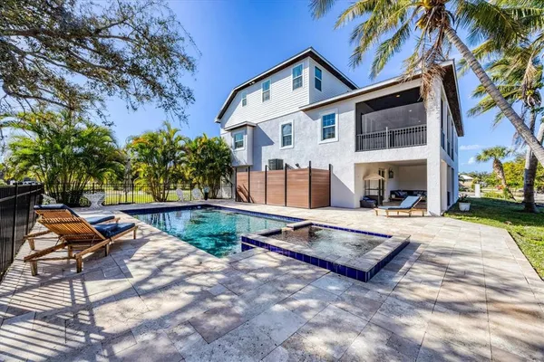 a view of a swimming pool with a patio and a yard
