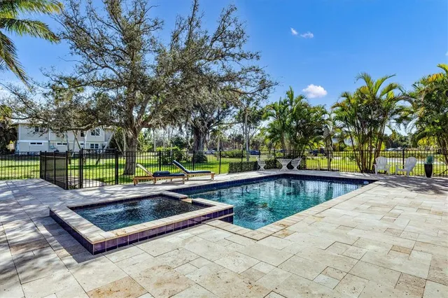 a view of a patio with chairs and plants