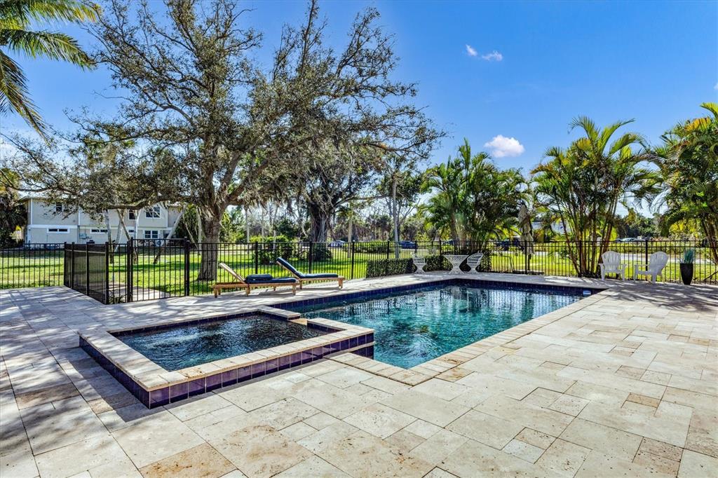 10050 Creekside Drive Placida, FL 33946 - Photo 40 of 52 a view of a swimming pool with a patio and a yard
