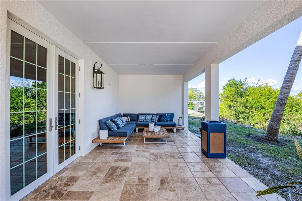 10050 Creekside Drive Placida, FL 33946 - Photo 41 of 52 a view of a patio with chairs and plants
