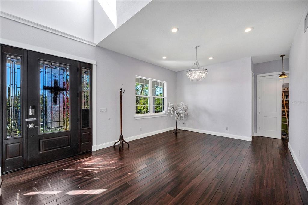 10050 Creekside Drive Placida, FL 33946 - Photo 9 of 52 an empty room with wooden floor and windows