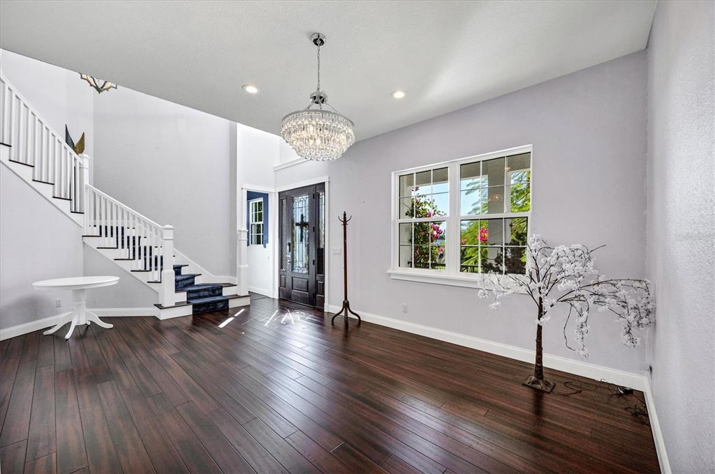 10050 Creekside Drive Placida, FL 33946 - Photo 10 of 52 a view of a livingroom with furniture wooden floor chandelier and windows