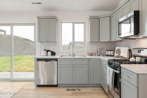 a kitchen with a sink stove and cabinets