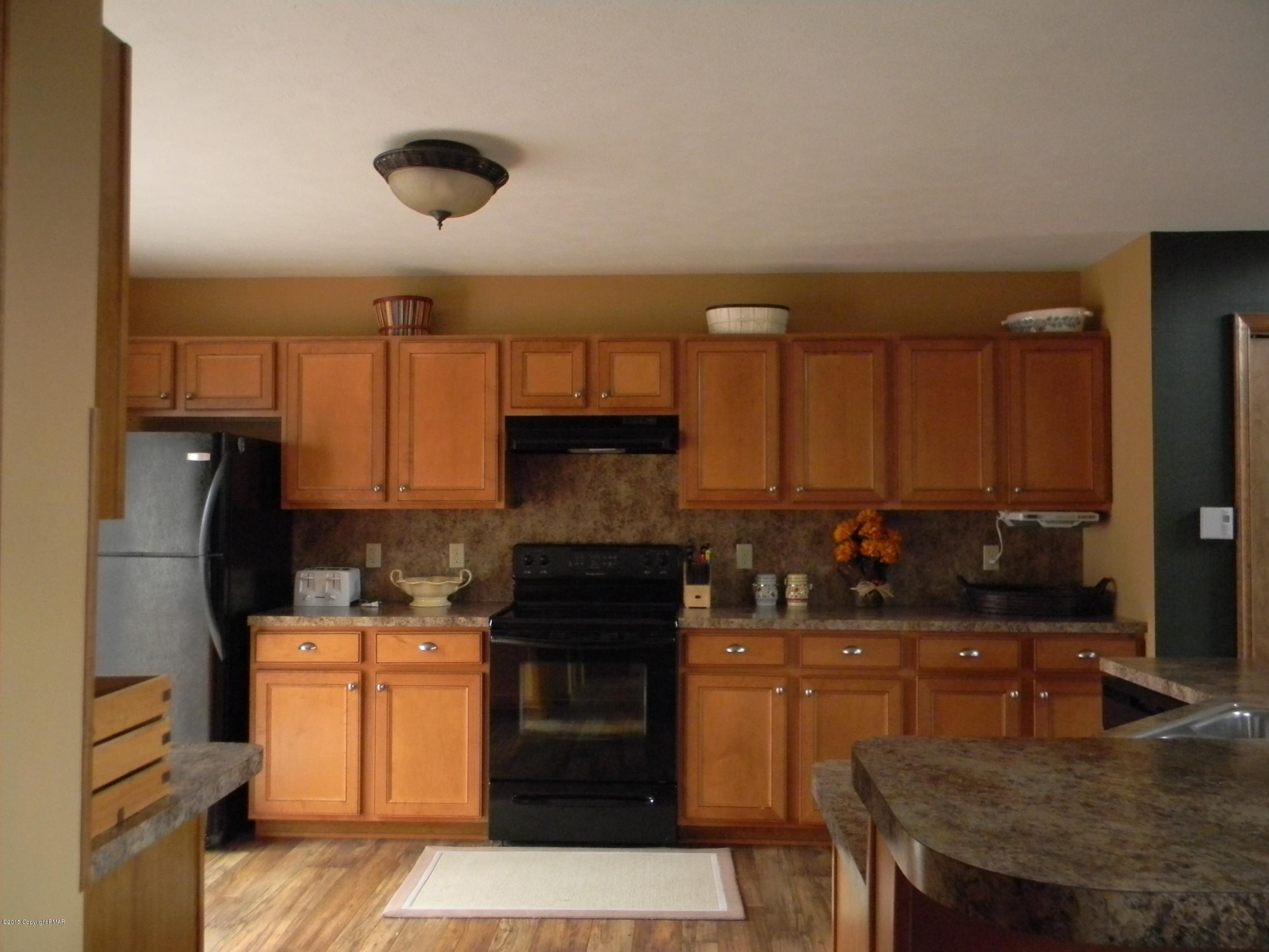 1122 Boulder Road Blakeslee, PA 18610 - Photo 3 of 8 a kitchen with granite countertop a sink a stove and refrigerator