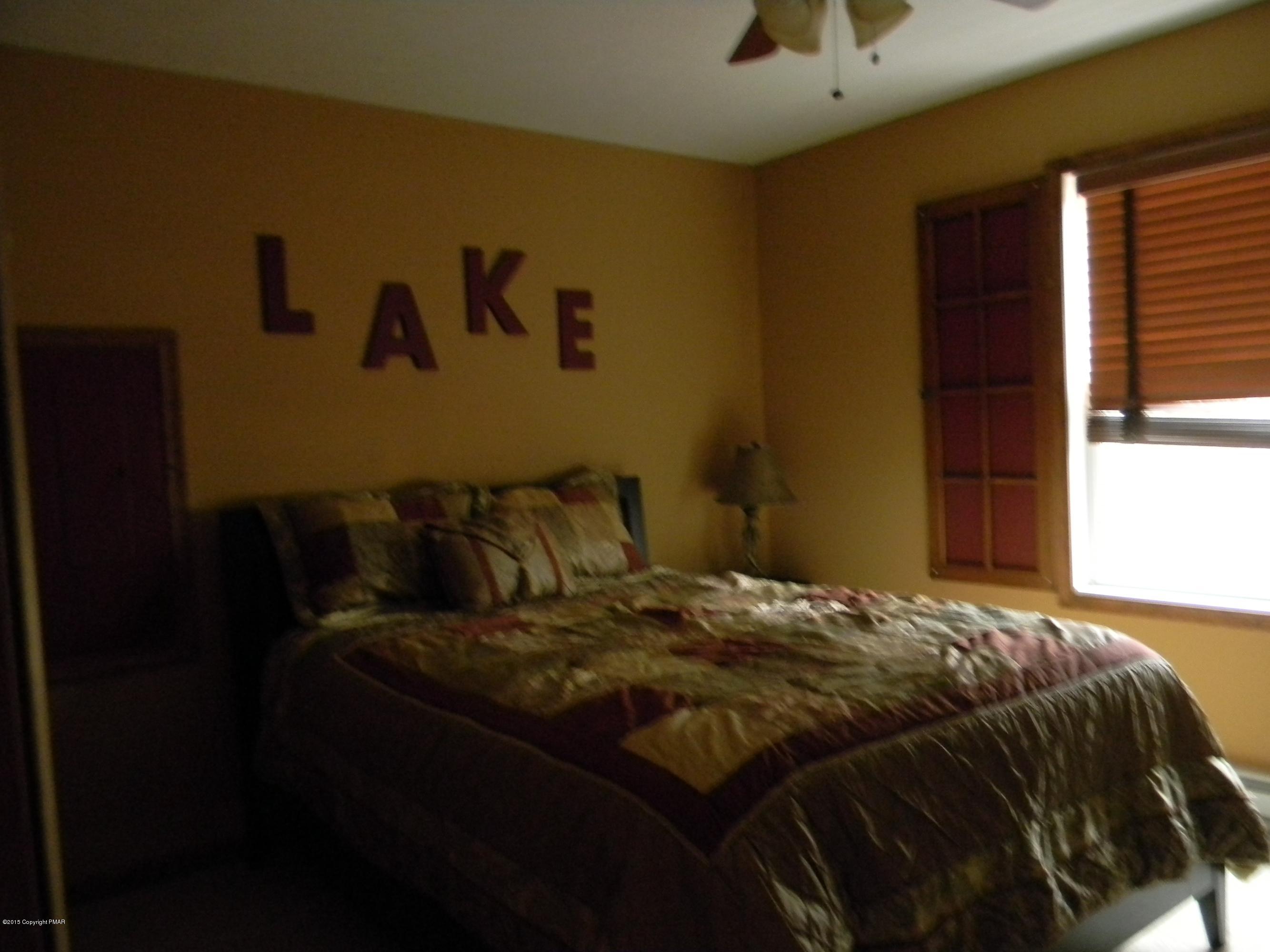 1122 Boulder Road Blakeslee, PA 18610 - Photo 5 of 8 a bed sitting in a bedroom next to a window
