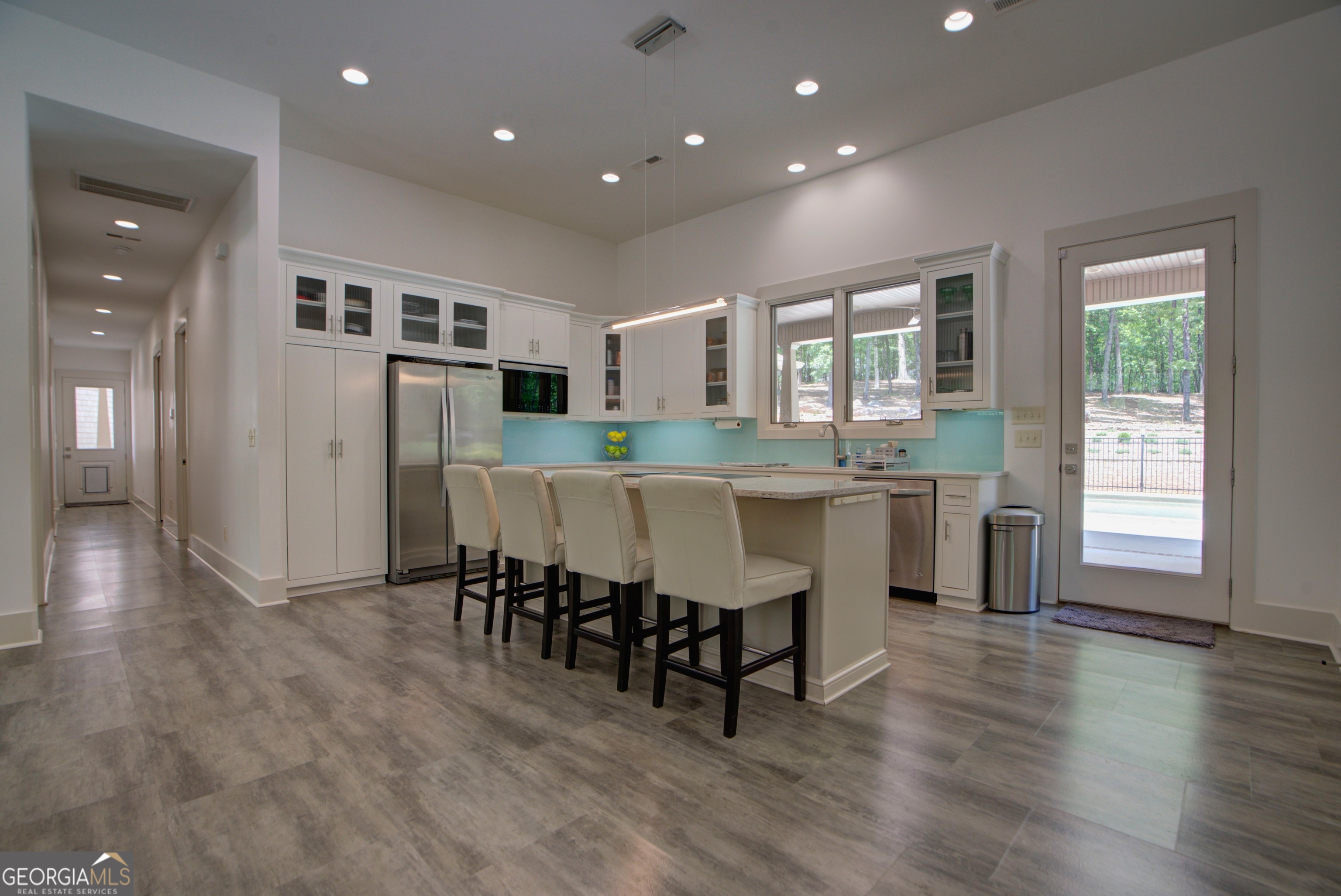 610 Kings Bridge Road Cave Spring, GA 30124 - Photo 9 of 72 a kitchen with stainless steel appliances granite countertop a stove a sink a refrigerator and a dining table with wooden floor