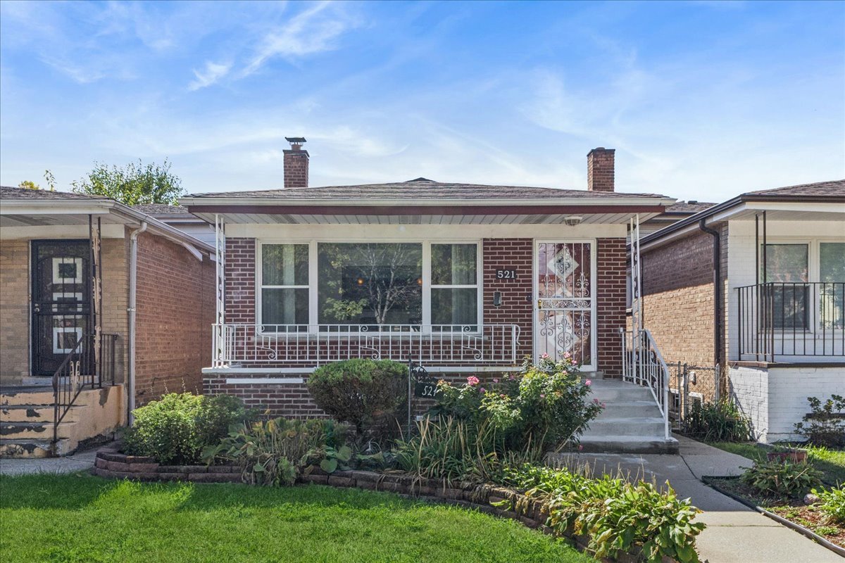 a front view of a house with a garden and plants