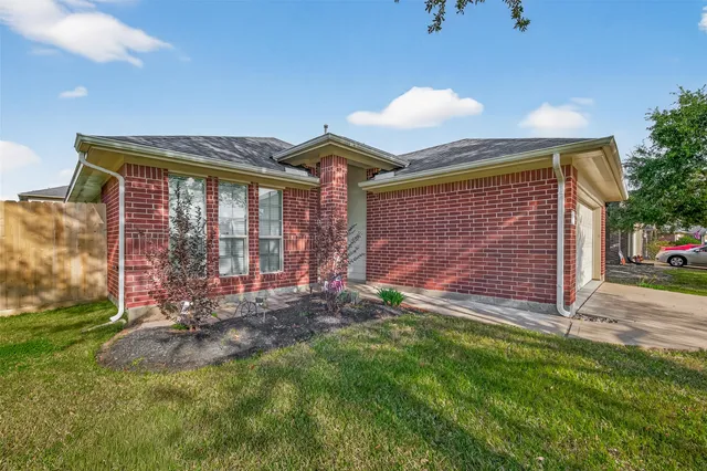 a living room with furniture two window and a chandelier