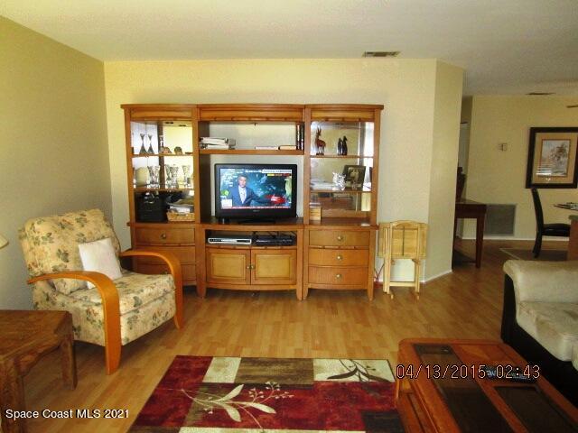 1595 Dawes Road Northeast Palm Bay, FL 32905 - Photo 3 of 20 a living room with furniture and a flat screen tv