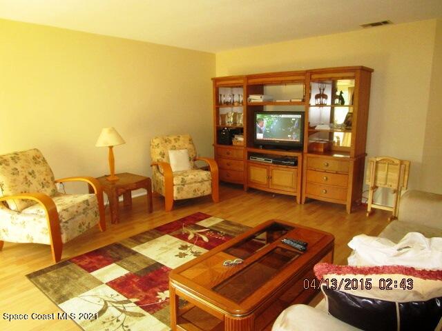 1595 Dawes Road Northeast Palm Bay, FL 32905 - Photo 4 of 20 a living room with furniture and a flat screen tv