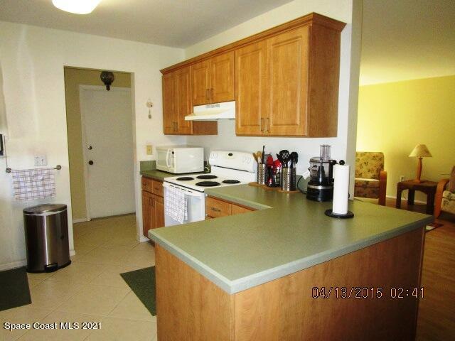 1595 Dawes Road Northeast Palm Bay, FL 32905 - Photo 8 of 20 a kitchen with stainless steel appliances a sink a counter top space and cabinets