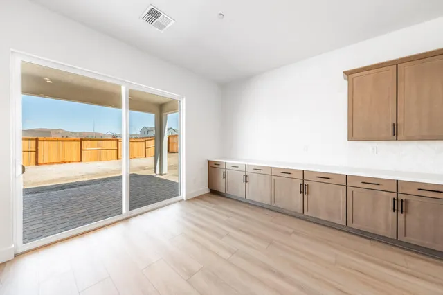 a large white kitchen with a sink and cabinets