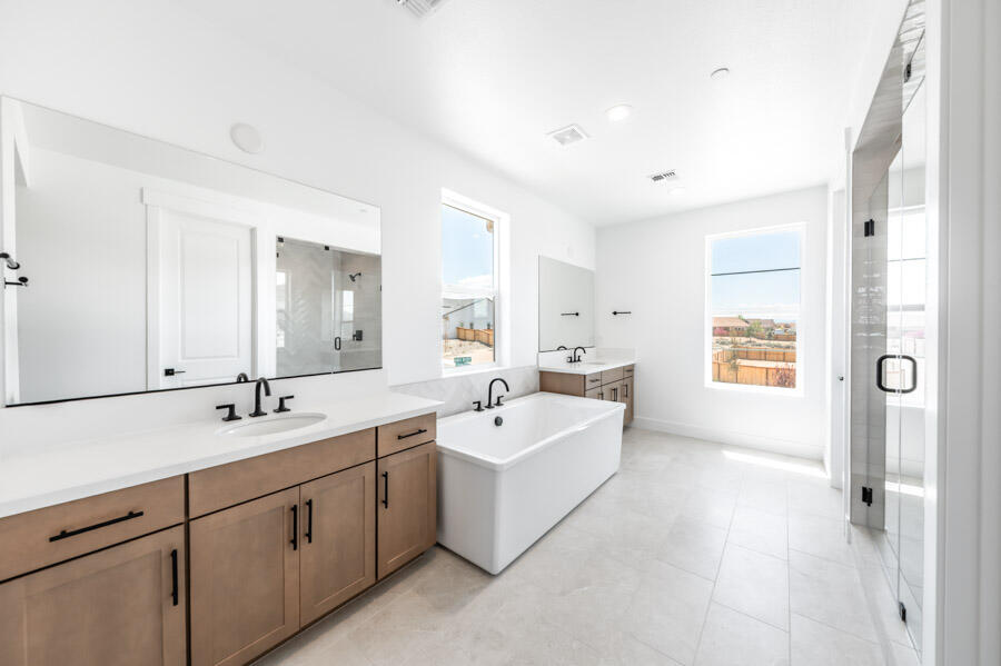 401 Pah Rah Rdg Drive, Unit MAGNOLIA 35 Sparks, NV 89441 - Photo 15 of 21 a spacious bathroom with double vanity a mirror a vanity and a bathtub