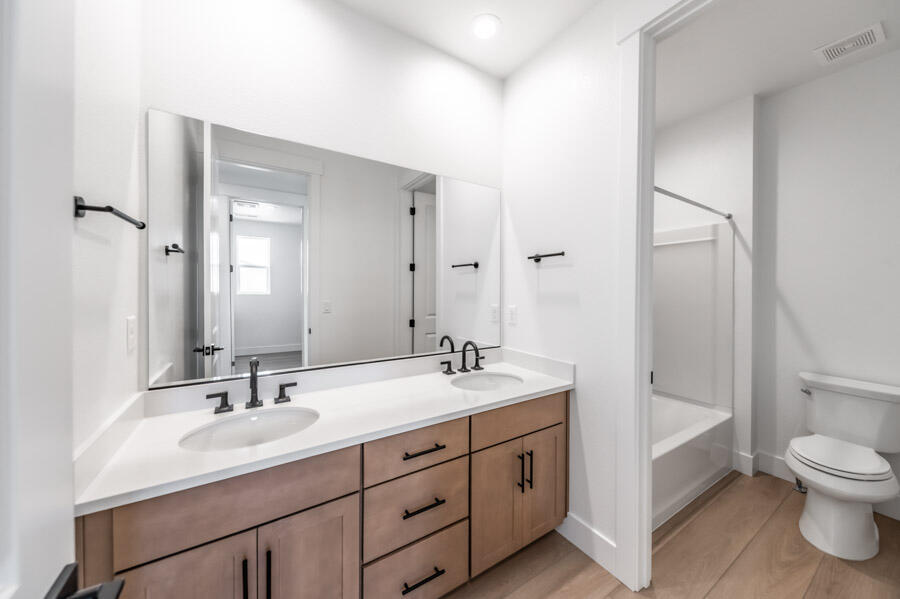 401 Pah Rah Rdg Drive, Unit MAGNOLIA 35 Sparks, NV 89441 - Photo 18 of 21 a bathroom with a double vanity sink toilet mirror and bathtub