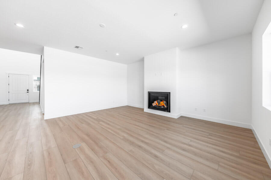 401 Pah Rah Rdg Drive, Unit MAGNOLIA 35 Sparks, NV 89441 - Photo 7 of 21 a view of an empty room with wooden floor and a fireplace