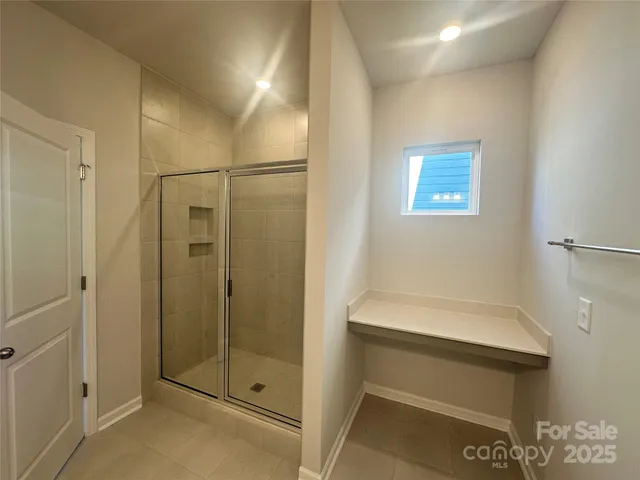 a bathroom with a shower and a sink