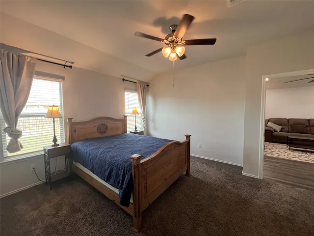 a spacious bedroom with a bed and a chandelier