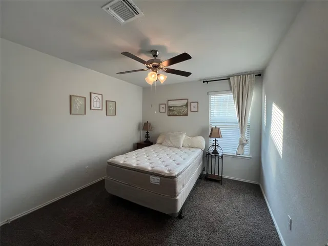 a room with a bed and a chandelier