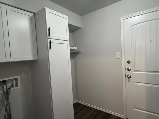 a white refrigerator freezer and a wooden floor