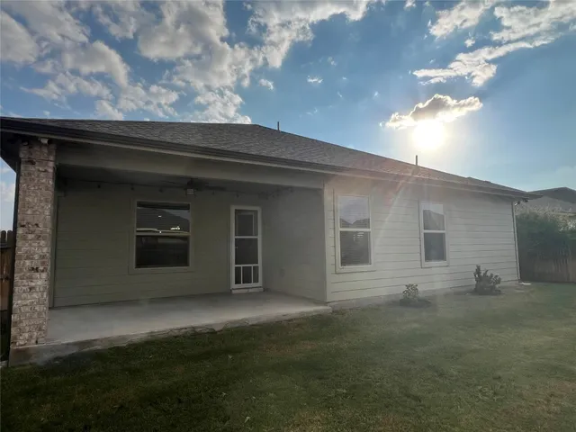 a view of house with backyard