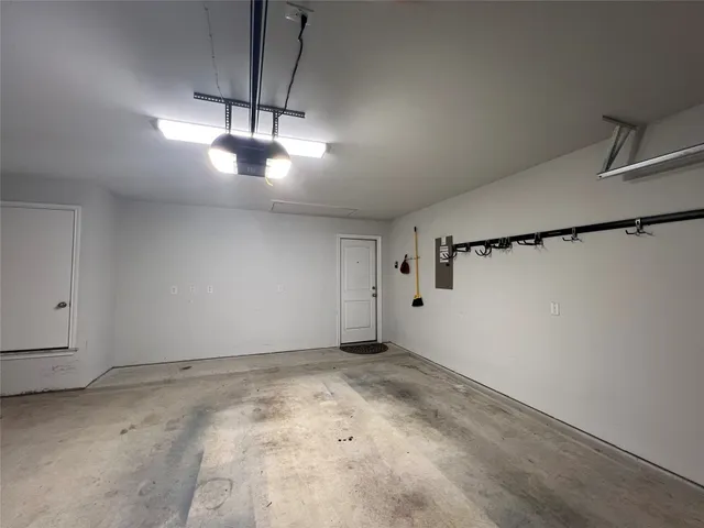 a view of an empty room and chandelier fan