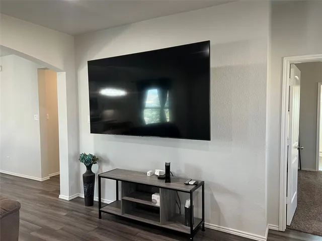 a living room with a flat screen tv and a fireplace