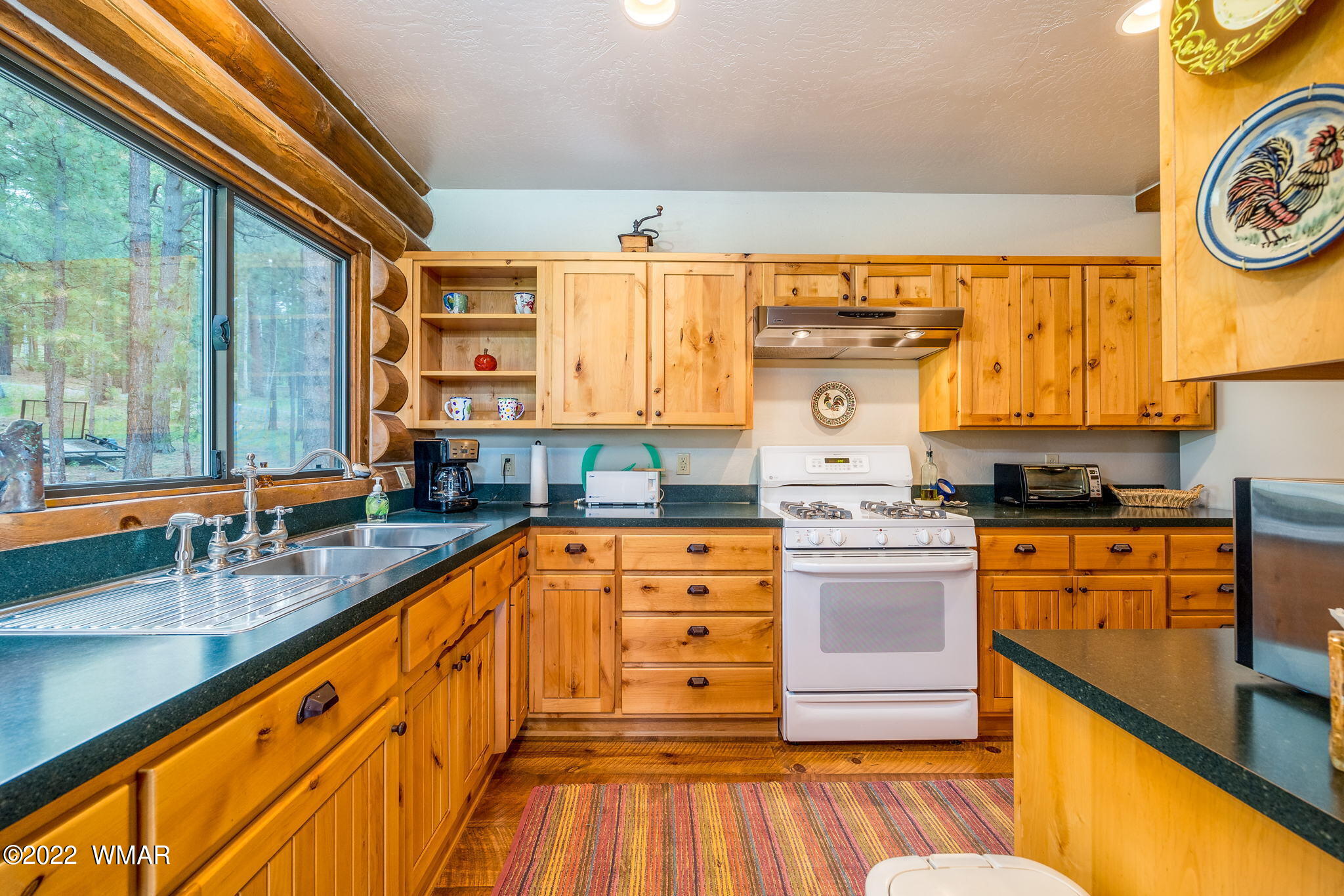 11 N1063 Greer, AZ 85927 - Photo 14 of 31 a large kitchen with stainless steel appliances a large window and a sink