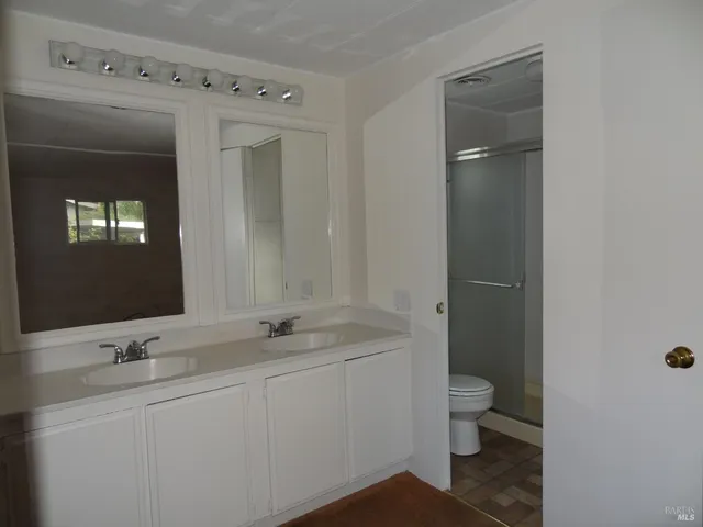 a bathroom with a toilet sink and mirror