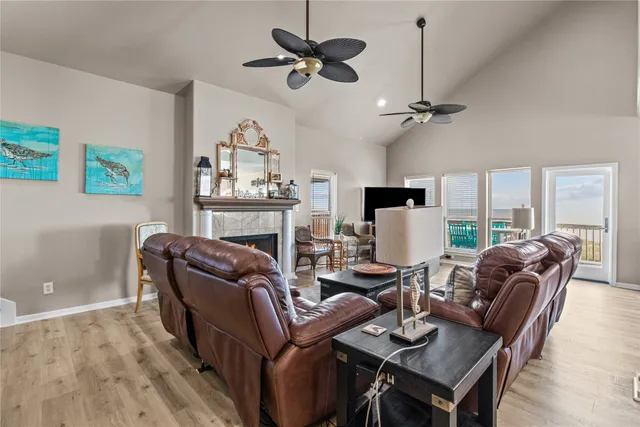 a living room with furniture a ceiling fan and a window