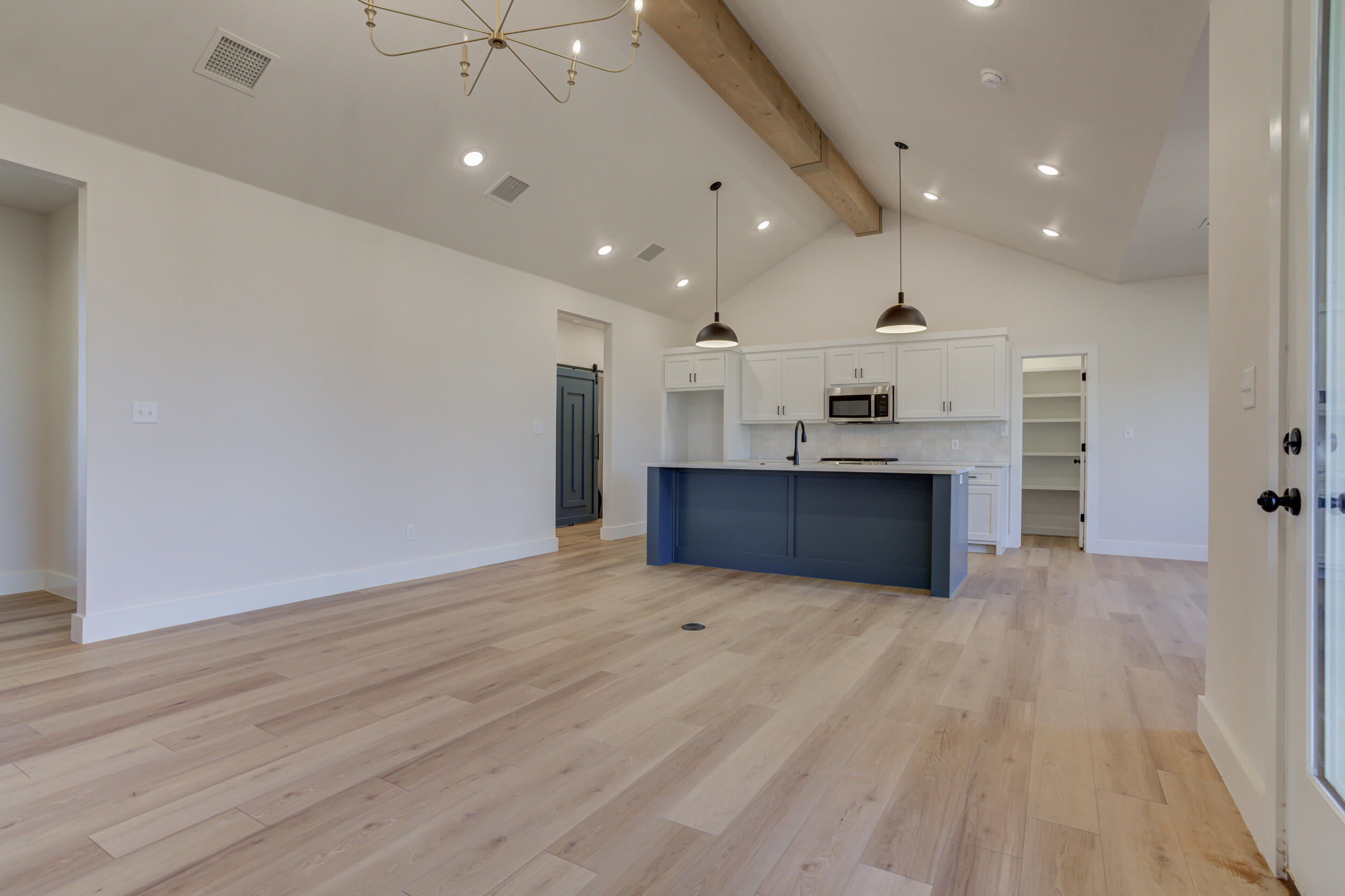 6913 13th Street Lubbock, TX 79416 - Photo 13 of 45 an empty room with wooden floor and windows