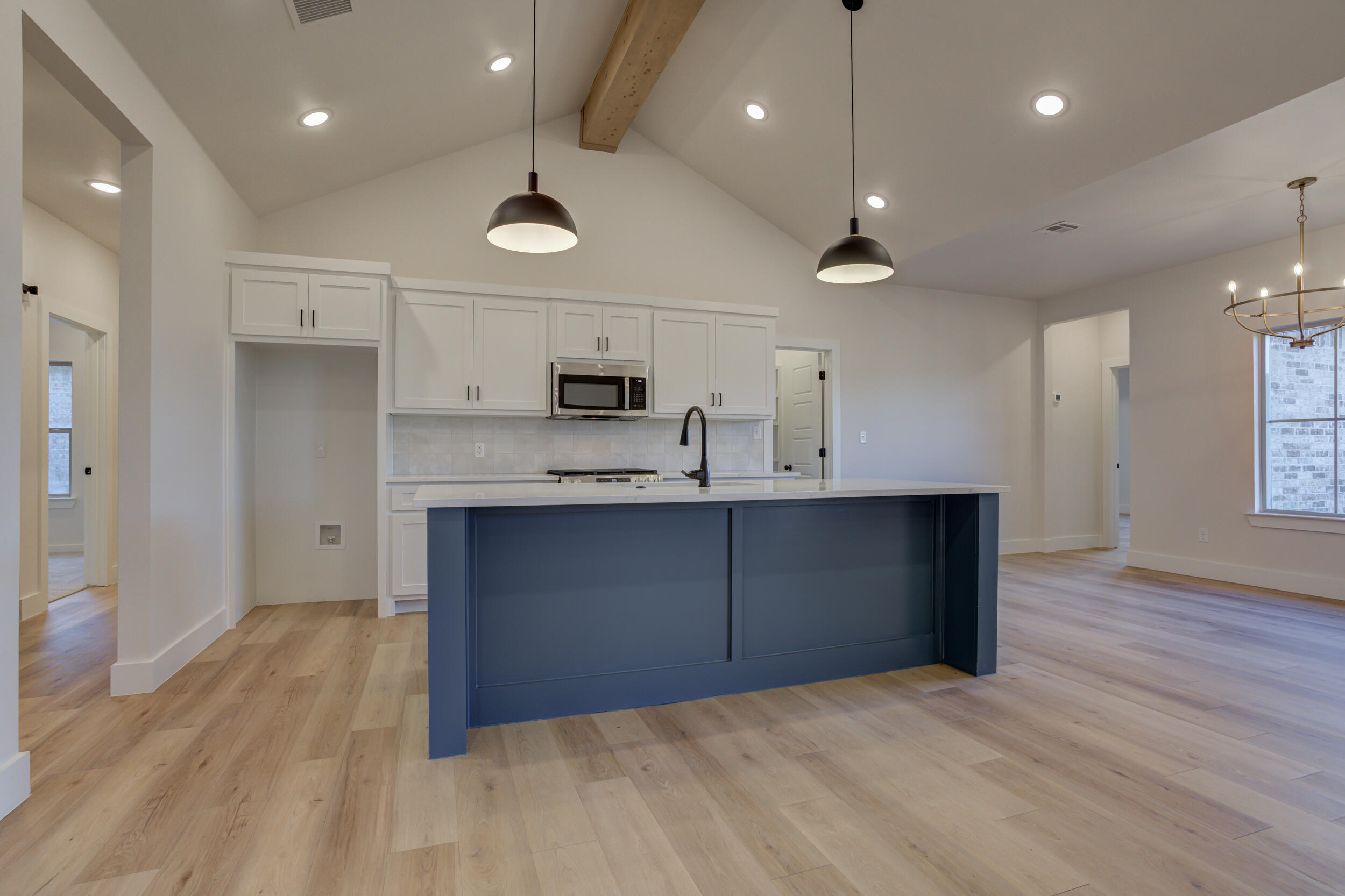 6913 13th Street Lubbock, TX 79416 - Photo 14 of 45 a kitchen with kitchen island a sink stainless steel appliances and cabinets