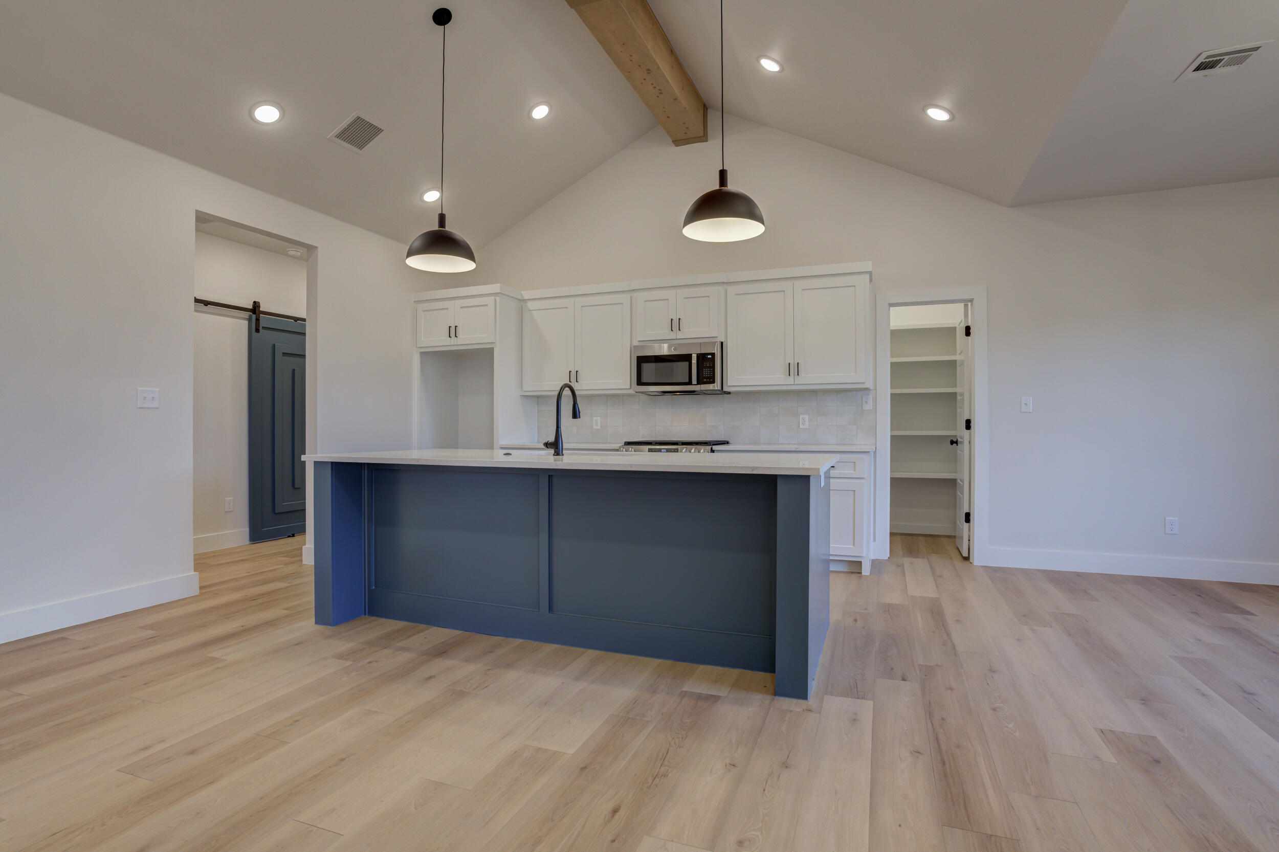 6913 13th Street Lubbock, TX 79416 - Photo 15 of 45 a kitchen with kitchen island a sink stainless steel appliances and cabinets