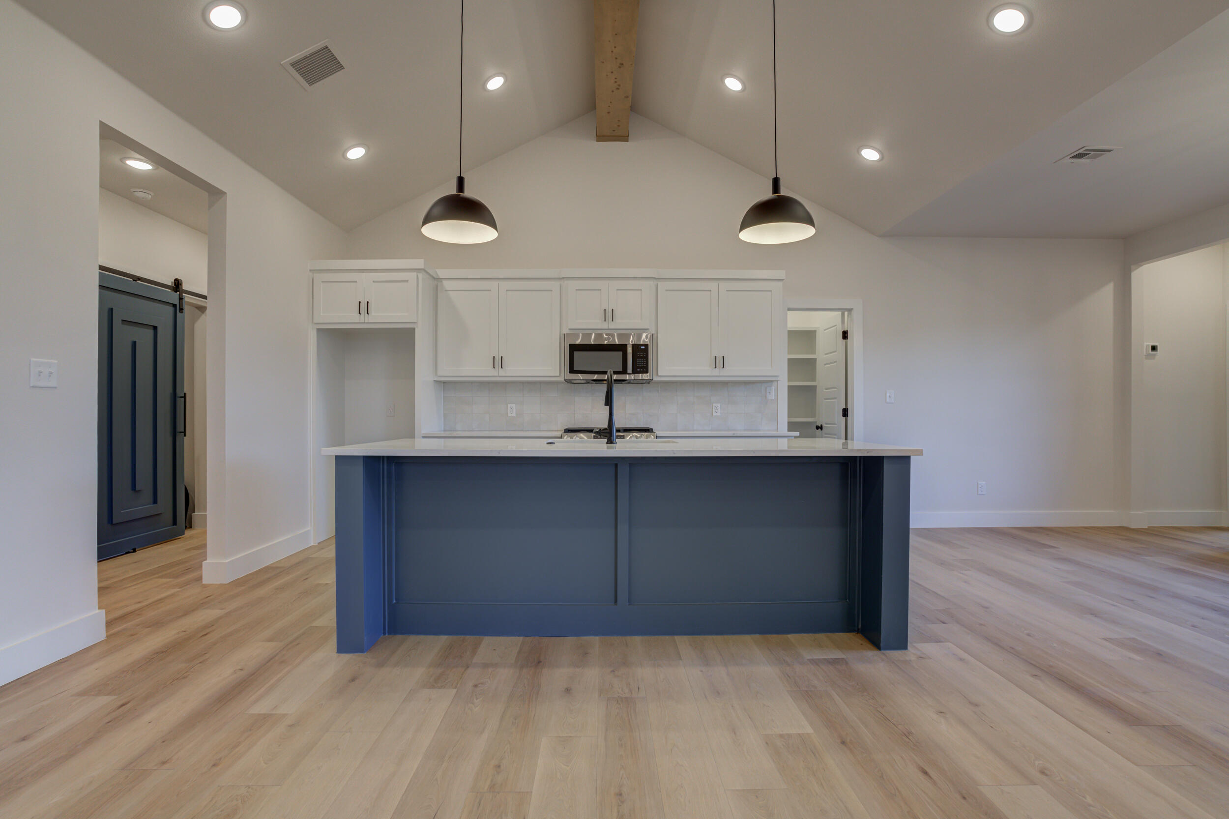 6913 13th Street Lubbock, TX 79416 - Photo 17 of 45 a view of a kitchen with a sink and wooden floor