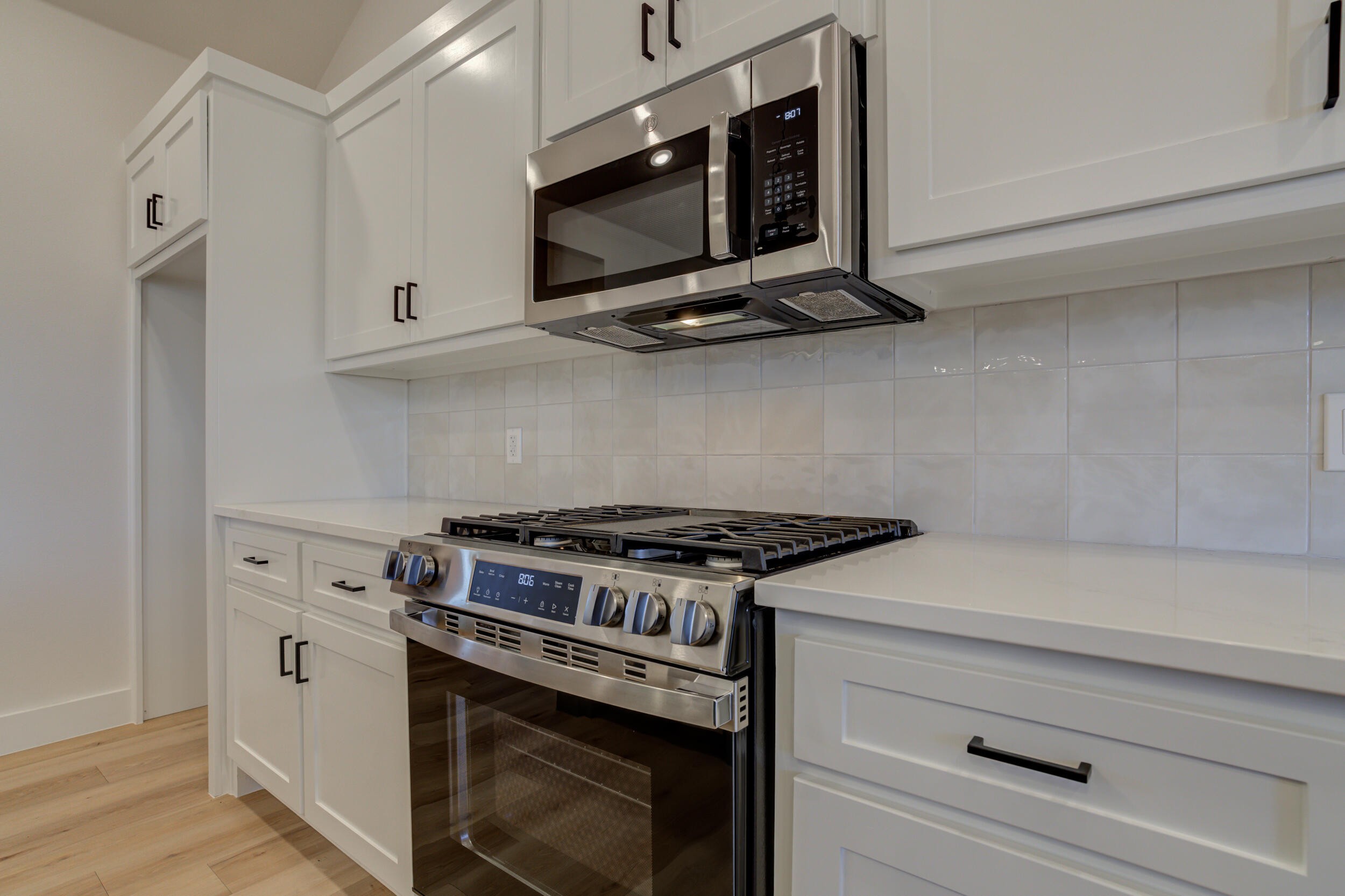 6913 13th Street Lubbock, TX 79416 - Photo 21 of 45 a stove top oven sitting inside of a kitchen