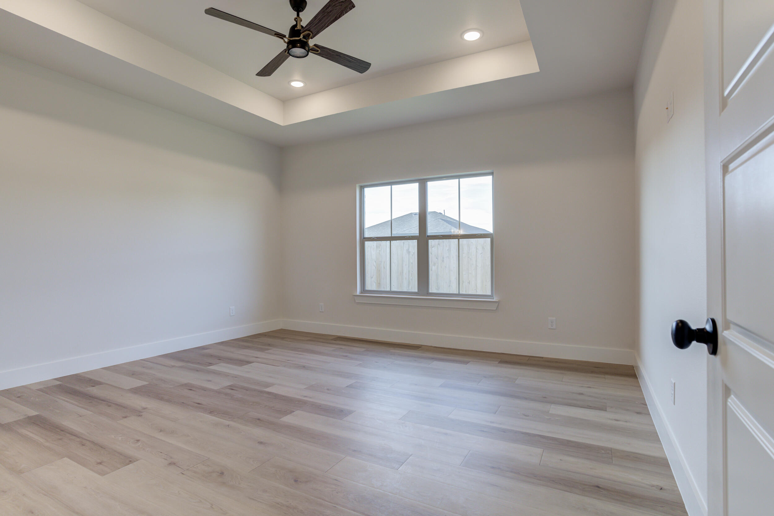 6913 13th Street Lubbock, TX 79416 - Photo 25 of 45 wooden floor in an empty room with a window