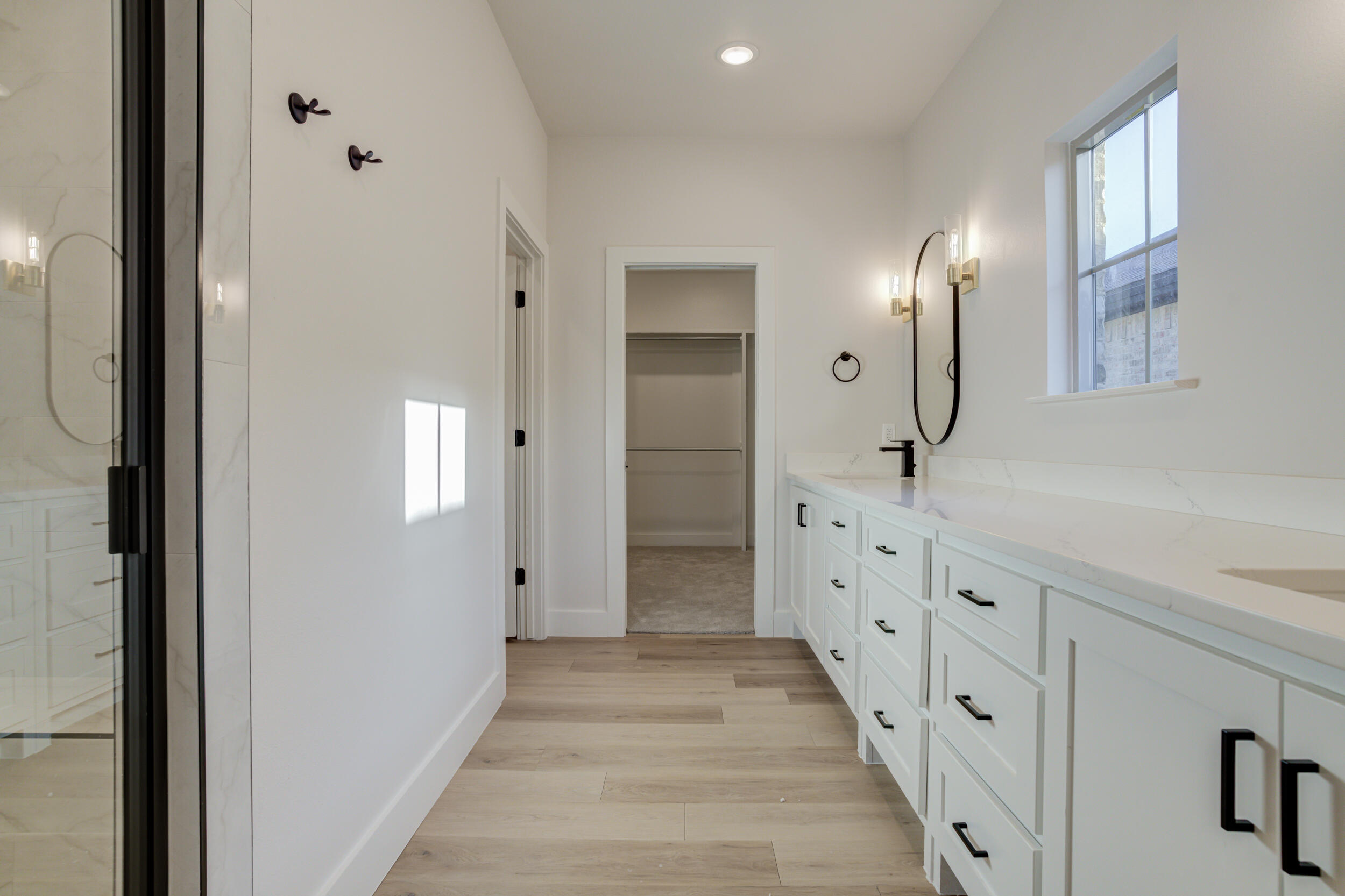6913 13th Street Lubbock, TX 79416 - Photo 29 of 45 a spacious bathroom with double vanity and mirrors