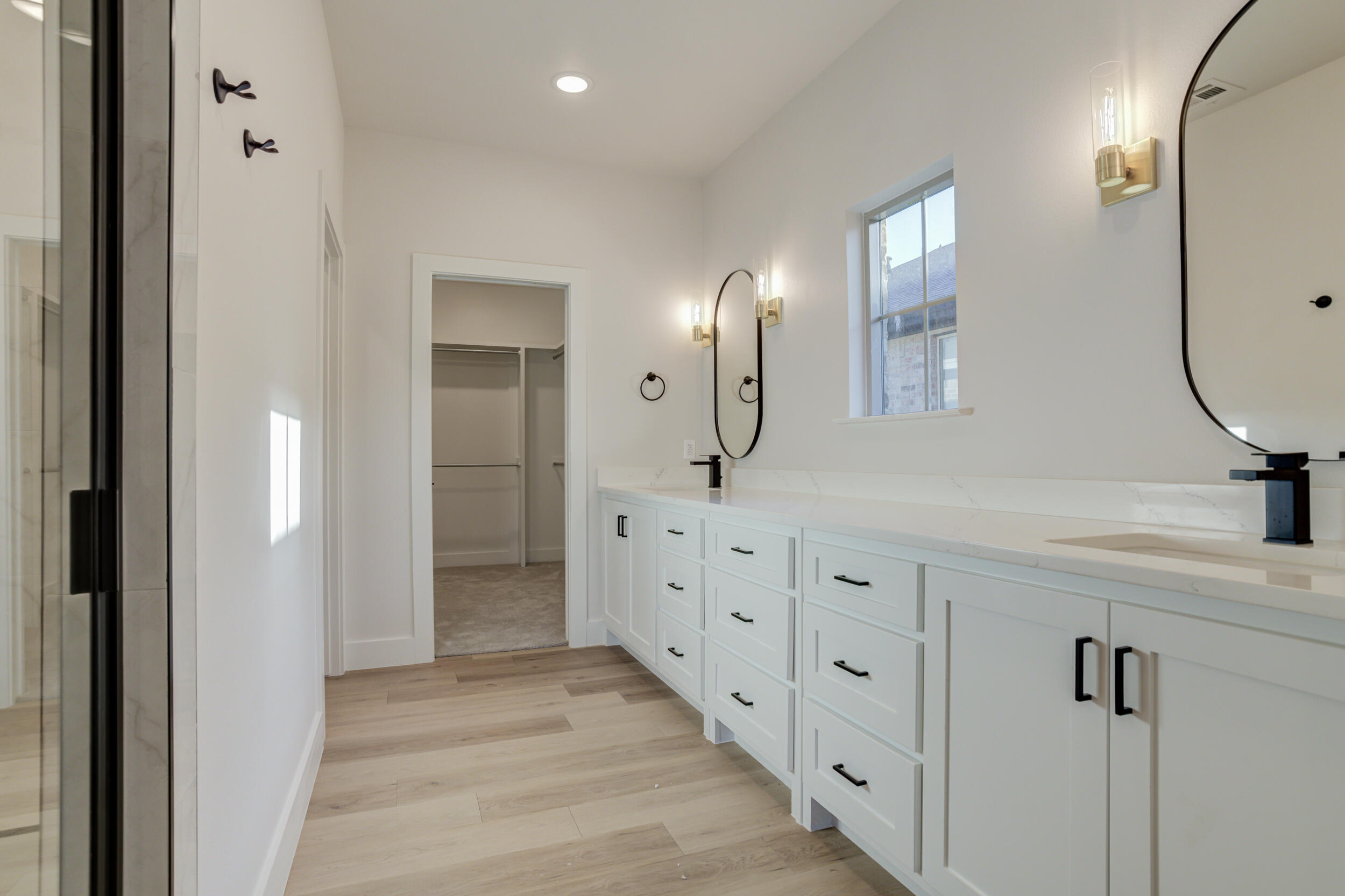 6913 13th Street Lubbock, TX 79416 - Photo 30 of 45 a bathroom with double vanity sink and a mirror