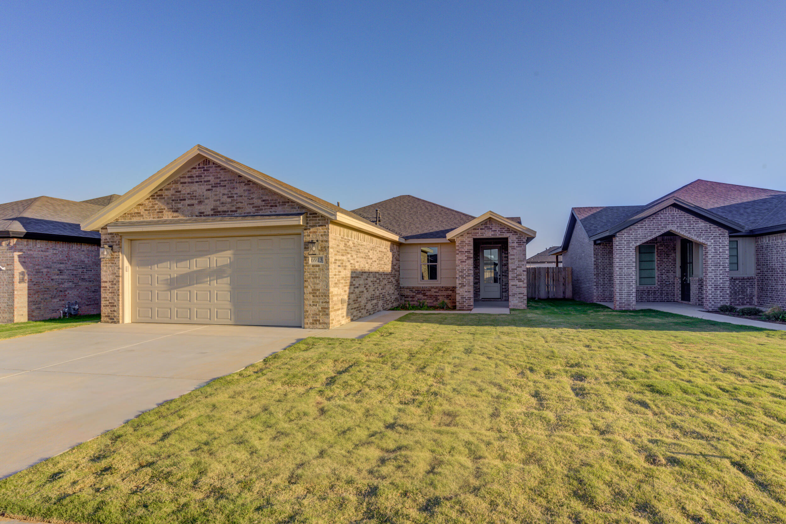 6913 13th Street Lubbock, TX 79416 - Photo 3 of 45 a front view of a house with yard