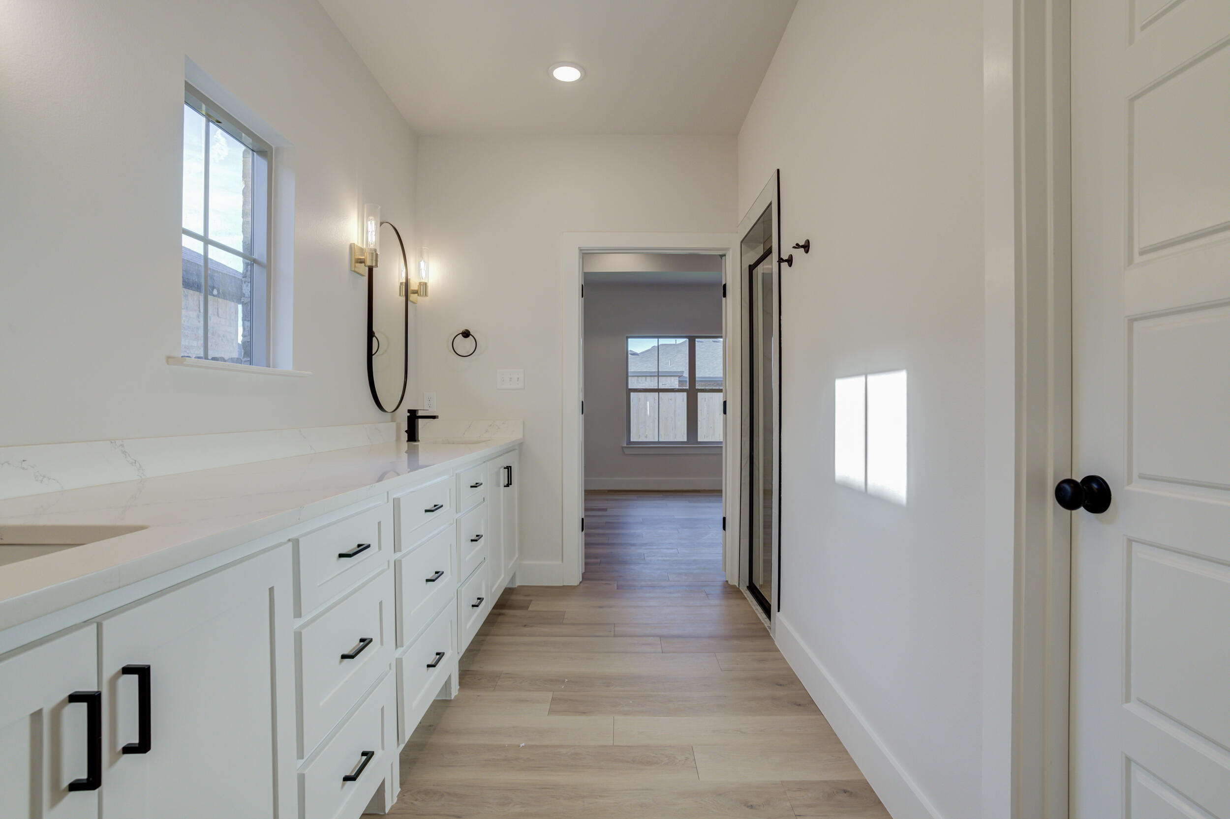 6913 13th Street Lubbock, TX 79416 - Photo 32 of 45 a bathroom with double vanity and a mirror
