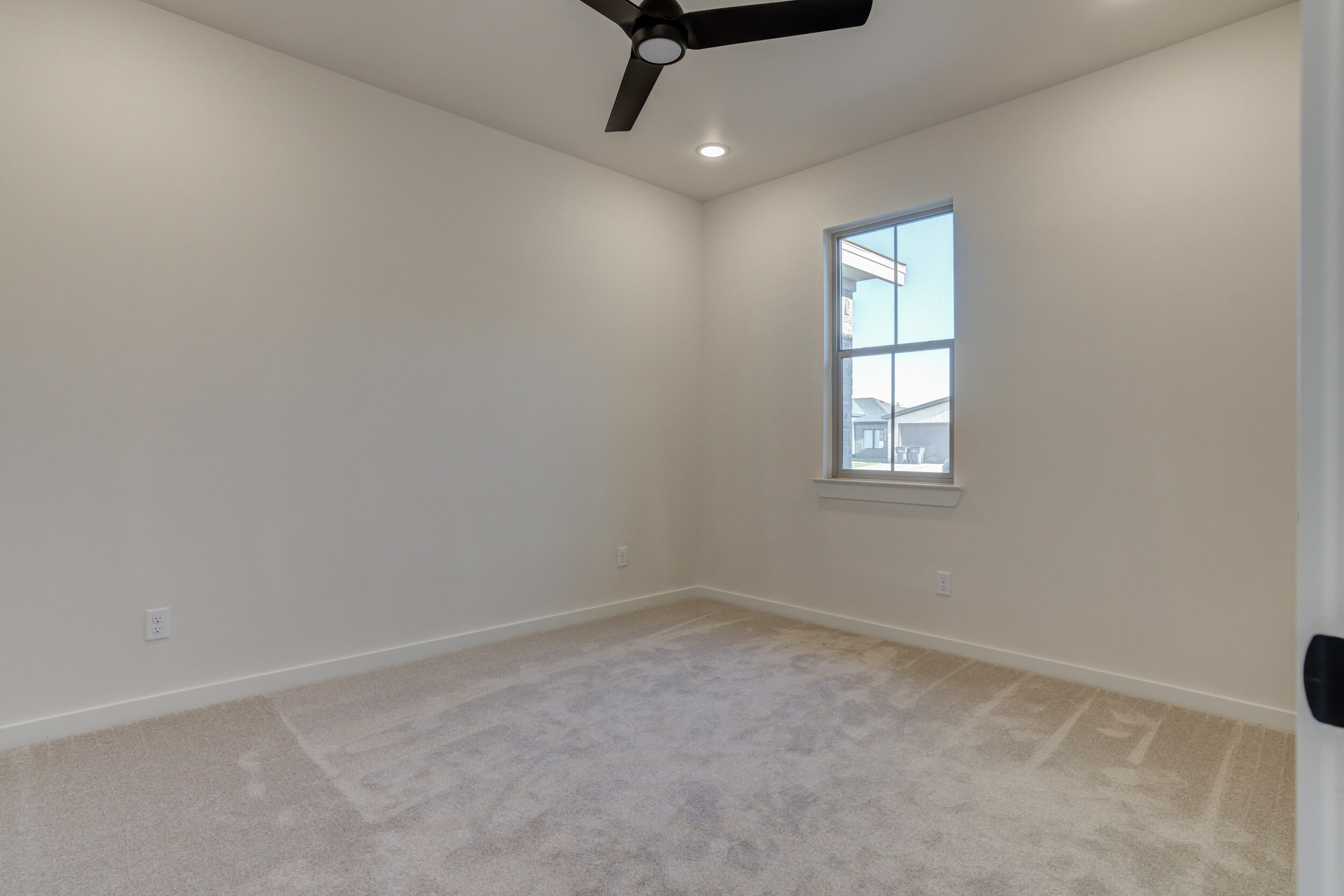 6913 13th Street Lubbock, TX 79416 - Photo 35 of 45 an empty room with windows and ceiling fan
