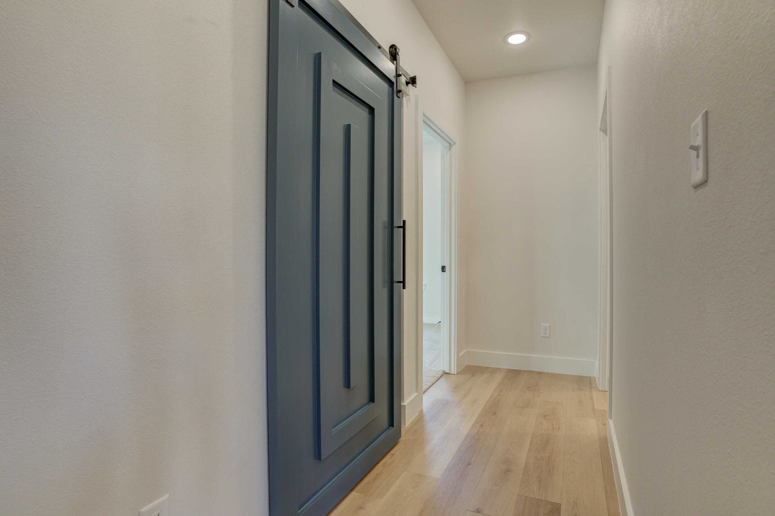 6913 13th Street Lubbock, TX 79416 - Photo 41 of 45 a view of a hallway with wooden floor
