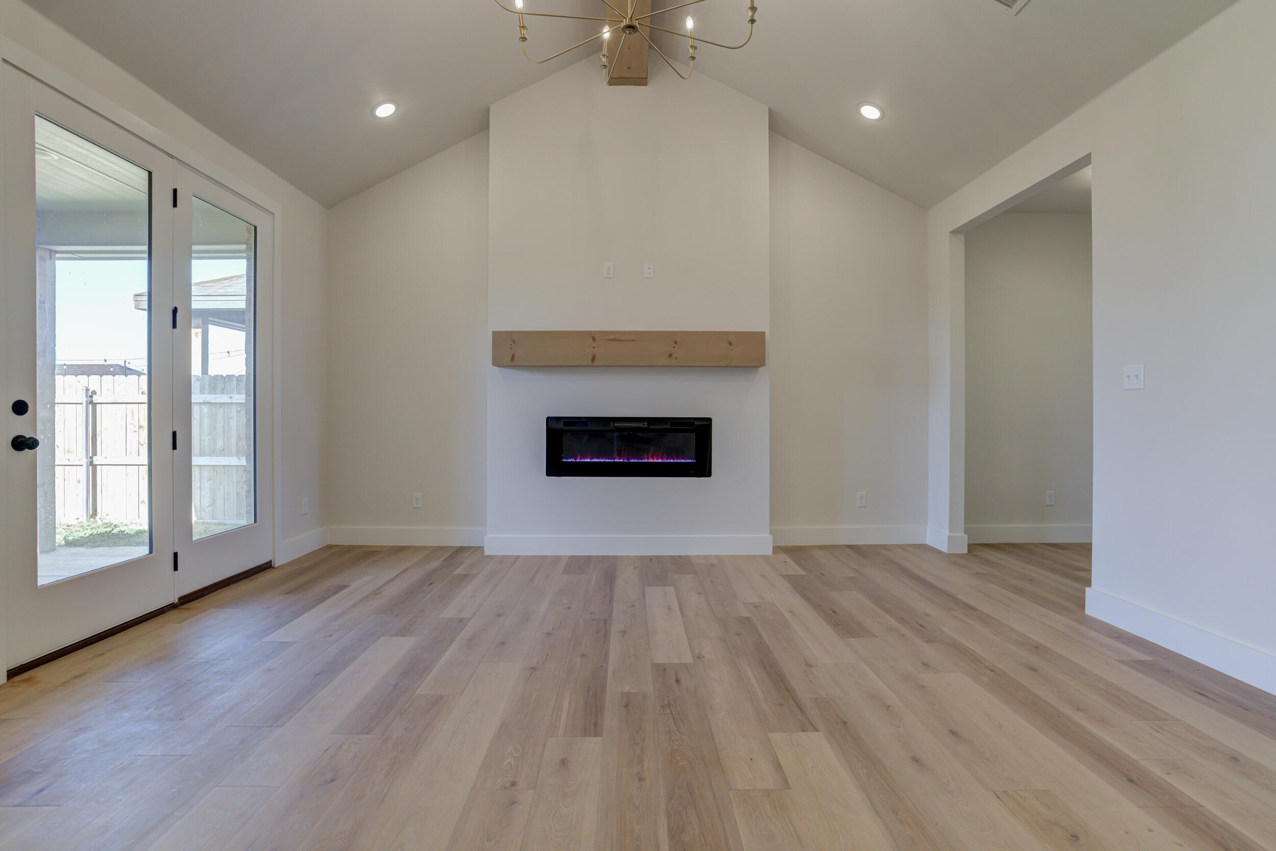 6913 13th Street Lubbock, TX 79416 - Photo 7 of 45 wooden floor fireplace and natural light in room