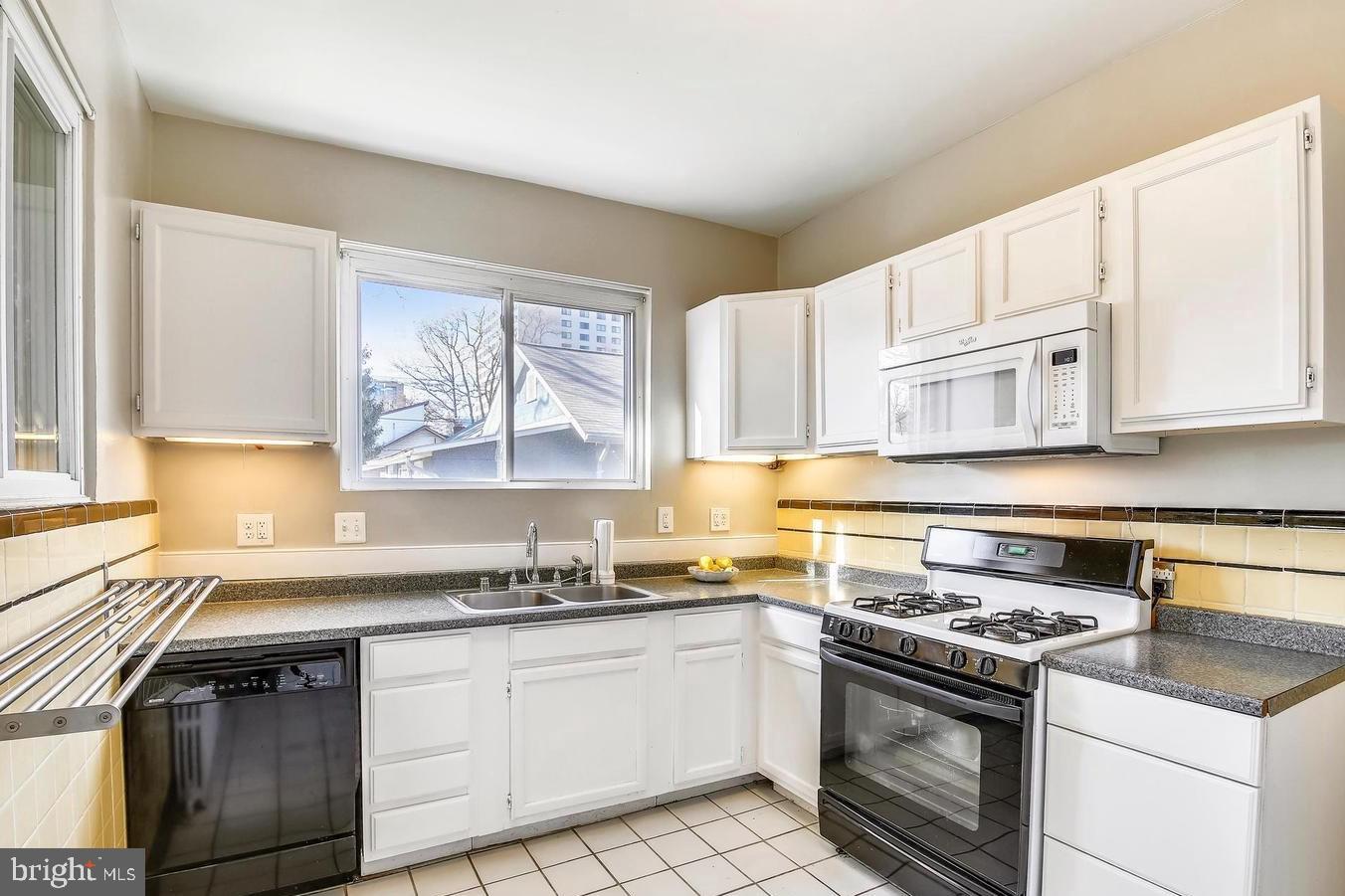 746 Thayer Avenue Silver Spring, MD 20910 - Photo 12 of 43 a kitchen with a stove a sink and a window