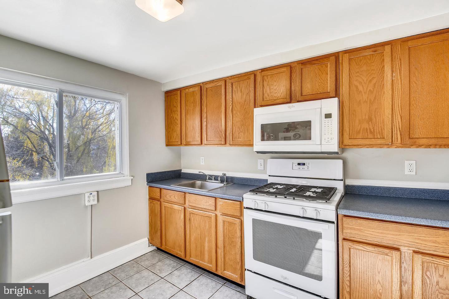 746 Thayer Avenue Silver Spring, MD 20910 - Photo 25 of 43 a kitchen with granite countertop cabinets stainless steel appliances a sink and a window