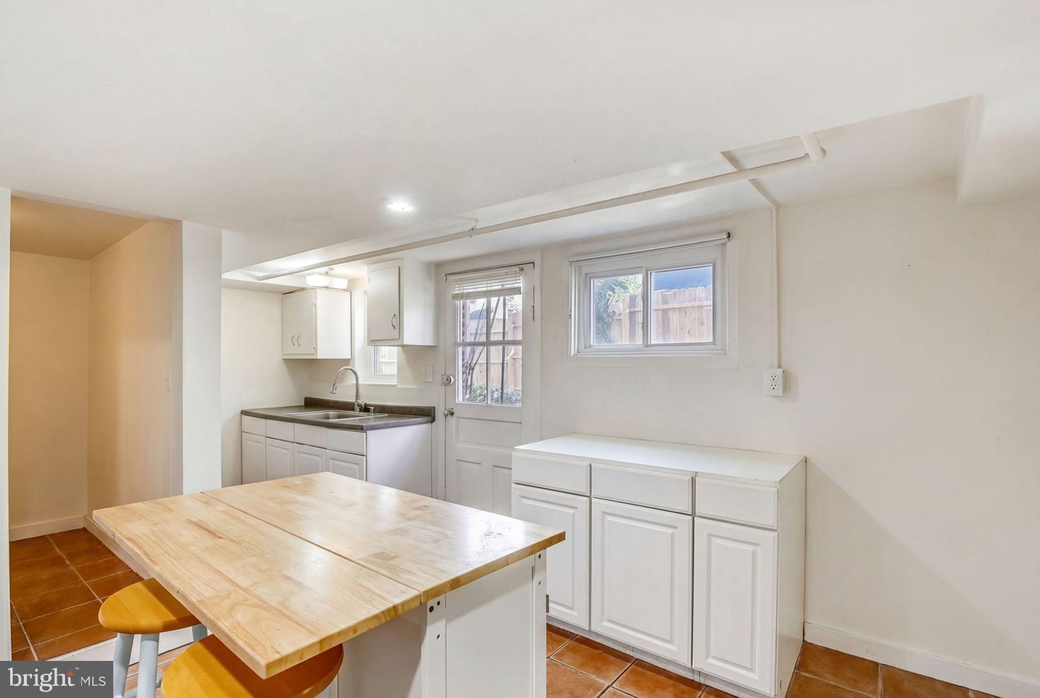 746 Thayer Avenue Silver Spring, MD 20910 - Photo 32 of 43 a kitchen with white cabinets and appliances