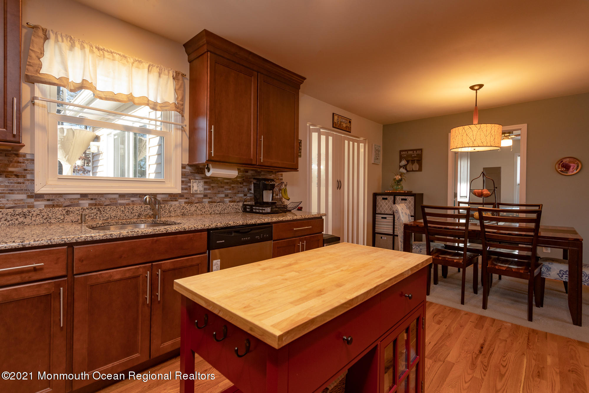 116 Toggle Road Manahawkin, NJ 08050 - Photo 12 of 26 a kitchen with kitchen island a sink table and chairs