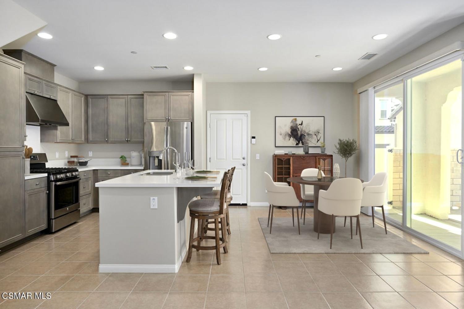 186 Stonegate Road Camarillo, CA 93010 - Photo 4 of 34 a kitchen that has a lot of cabinets in it with stainless steel appliances granite countertop a stove a sink a refrigerator and a dining table